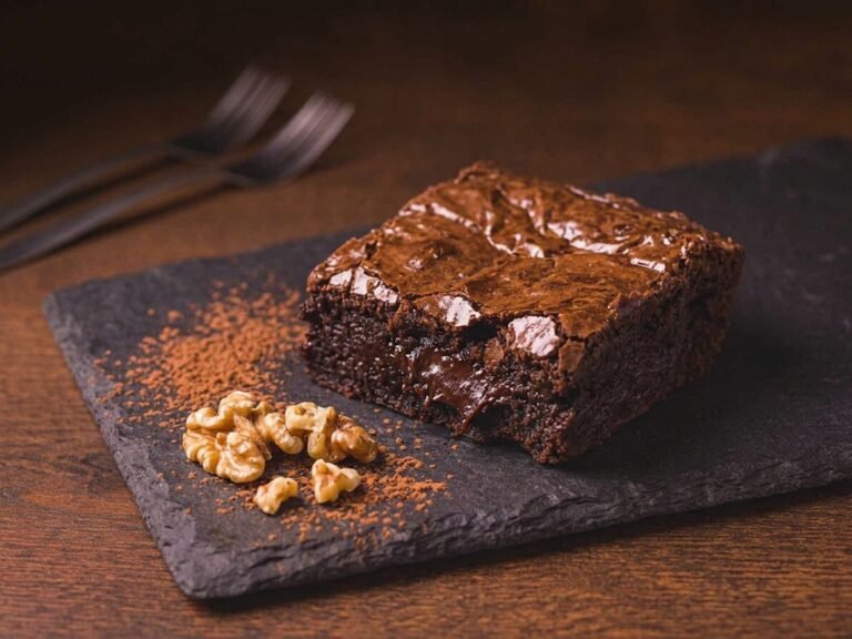 Ketaco vegan brownie, dense and fudgy with walnuts on slate